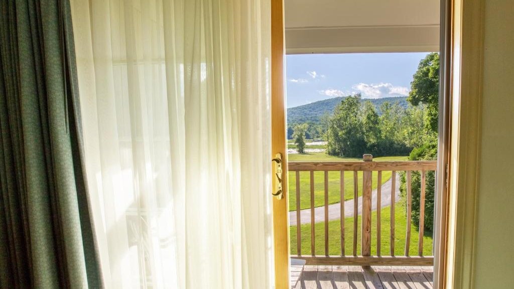 Deluxe King room with private balcony overlooking Berkshire mountain views at The Yankee Inn