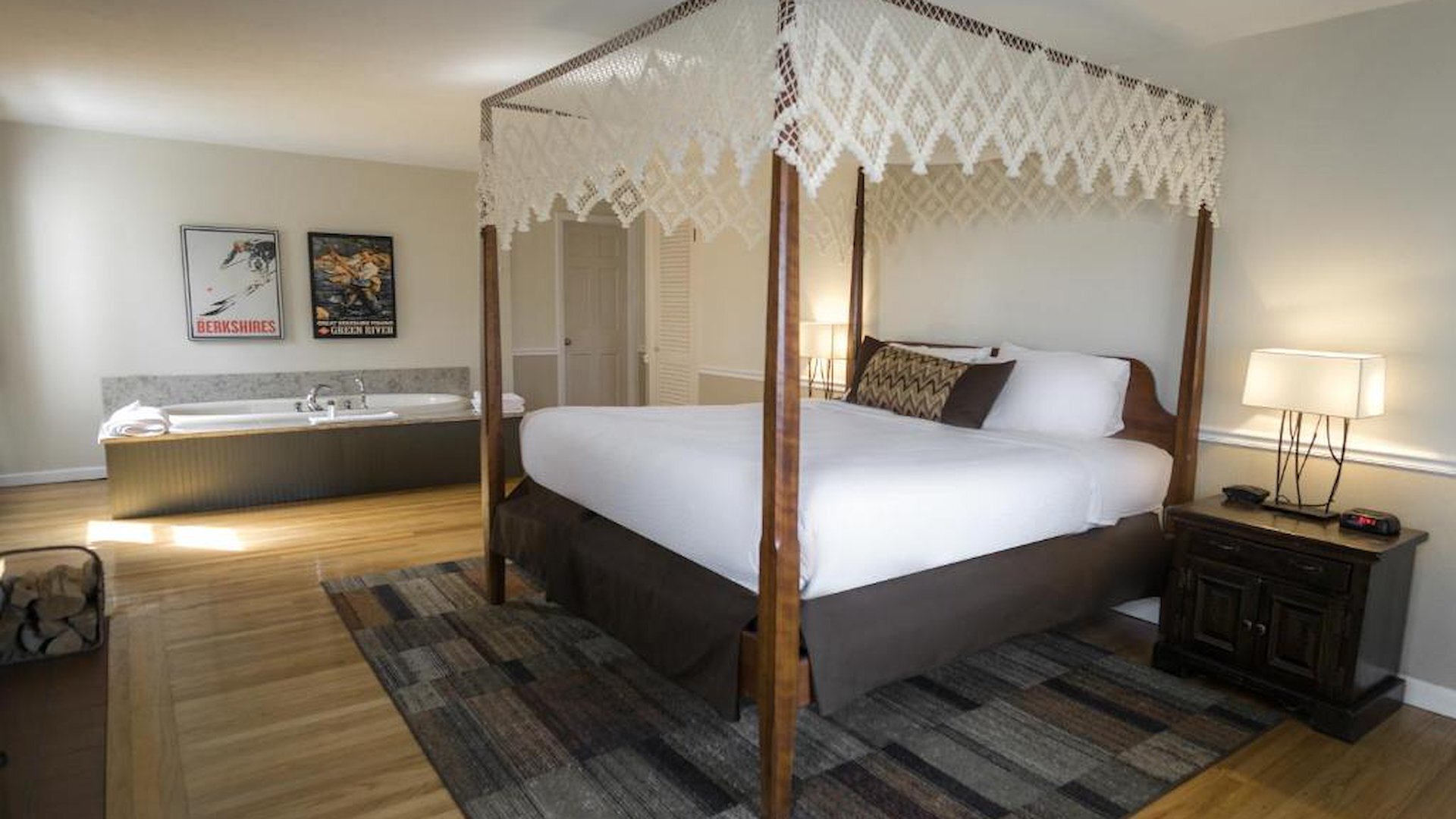King Superior room featuring a canopy four-poster bed and jetted tub at The Yankee Inn in Lenox