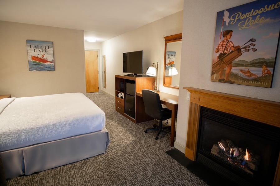 King Deluxe Room featuring vintage Berkshires lake artwork, gas fireplace, and well-equipped work desk