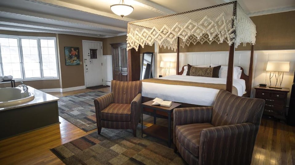 Spacious King Superior Room with canopy bed, in-room jetted tub, and private sitting area at The Yankee Inn in the Berkshires