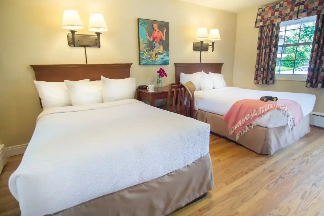 South Lodge motel-style room with two double beds and vintage Berkshires artwork at The Yankee Inn