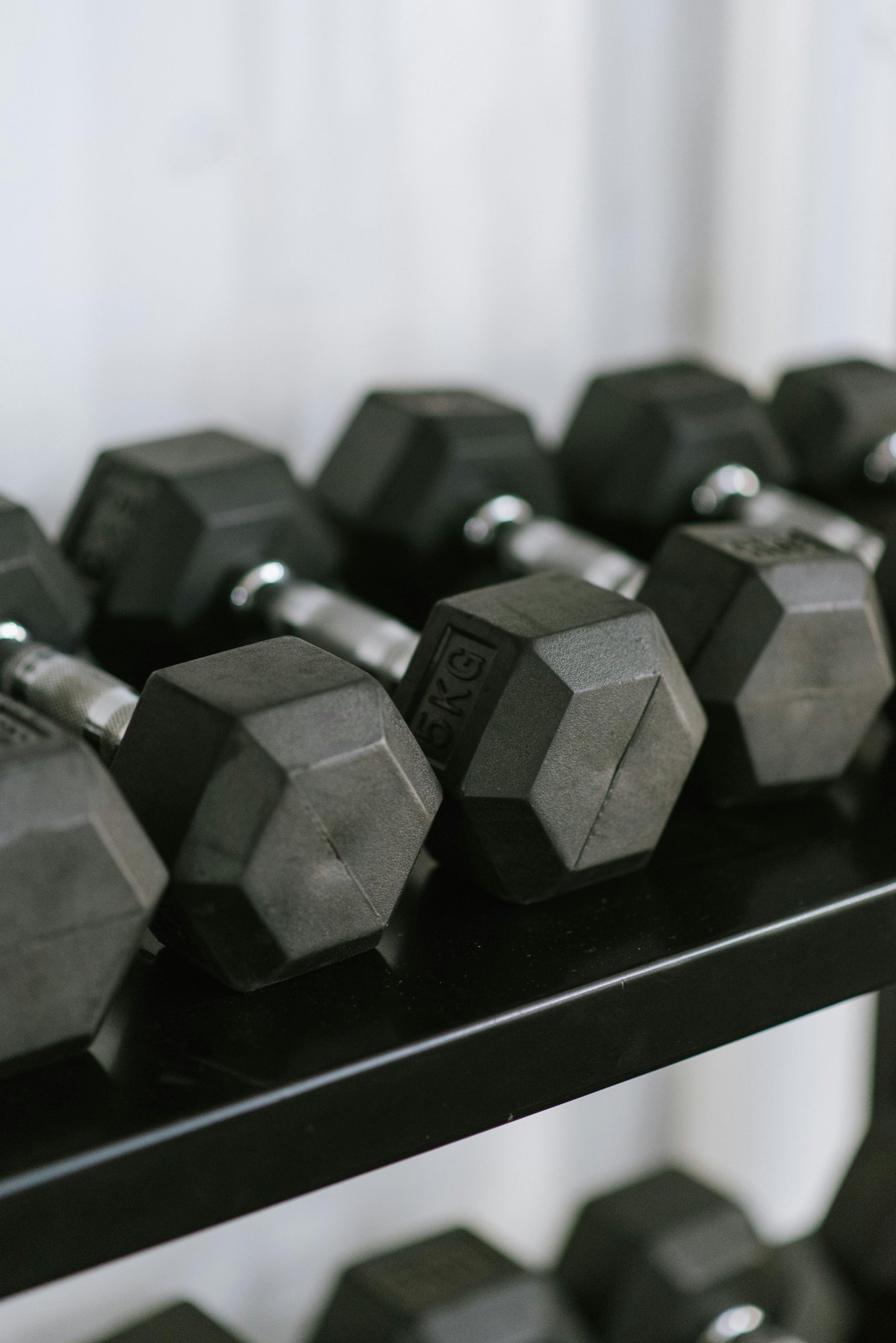 Free weight dumbbells racked at the on-site 24-hour fitness center