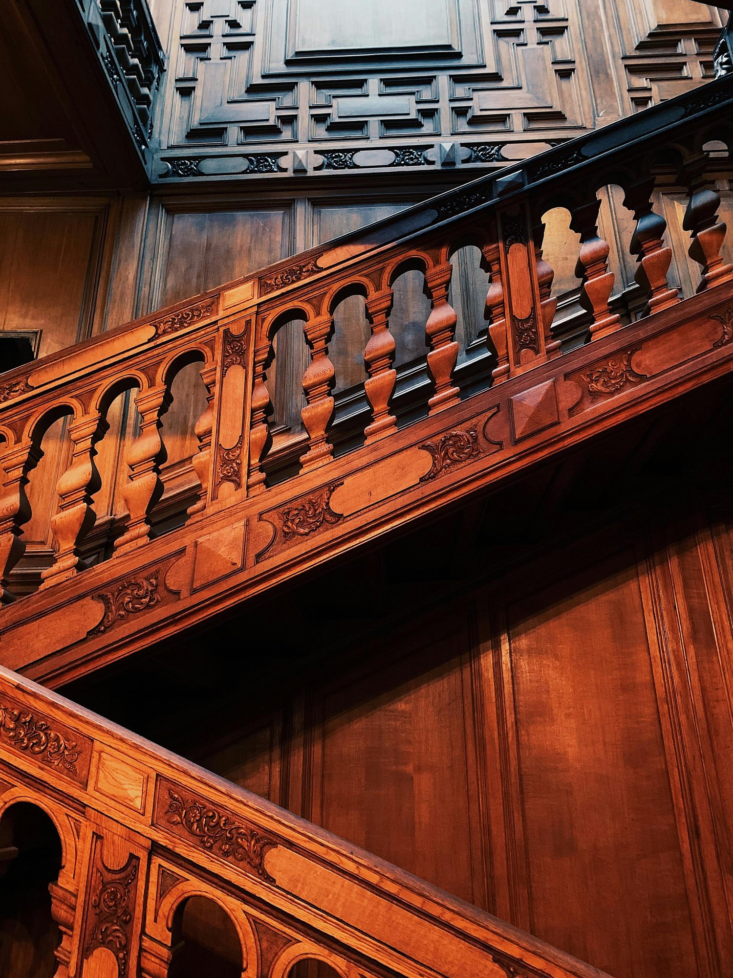 Ornate carved wooden staircase inside a historic Gilded Age mansion in Lenox Massachusetts