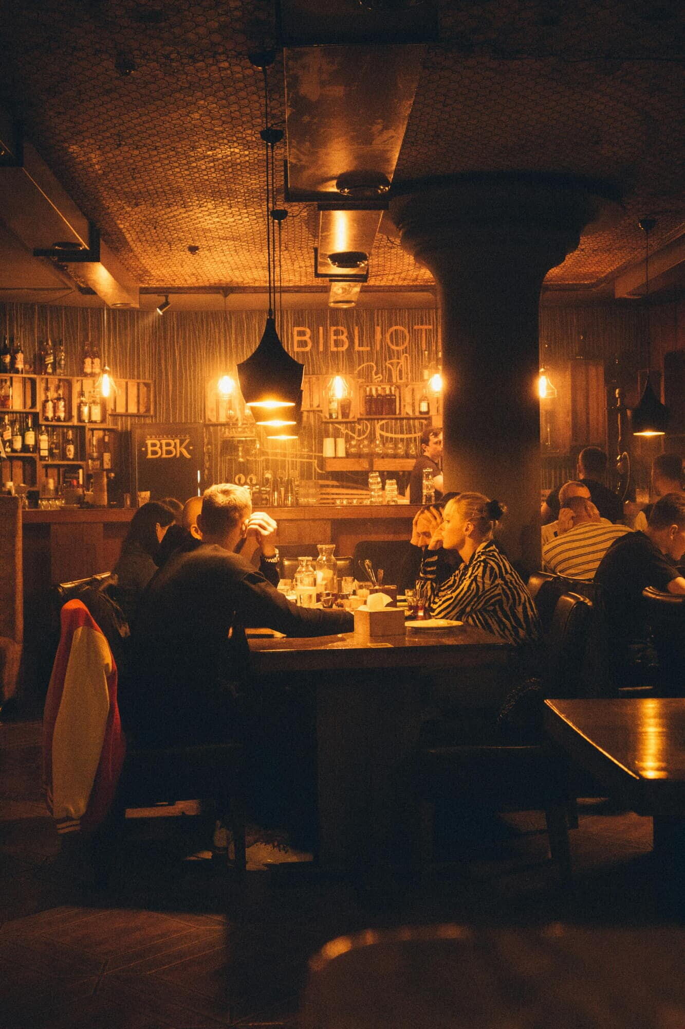 Guests enjoying dinner and drinks in a cozy warmly lit bar and lounge in the Berkshires