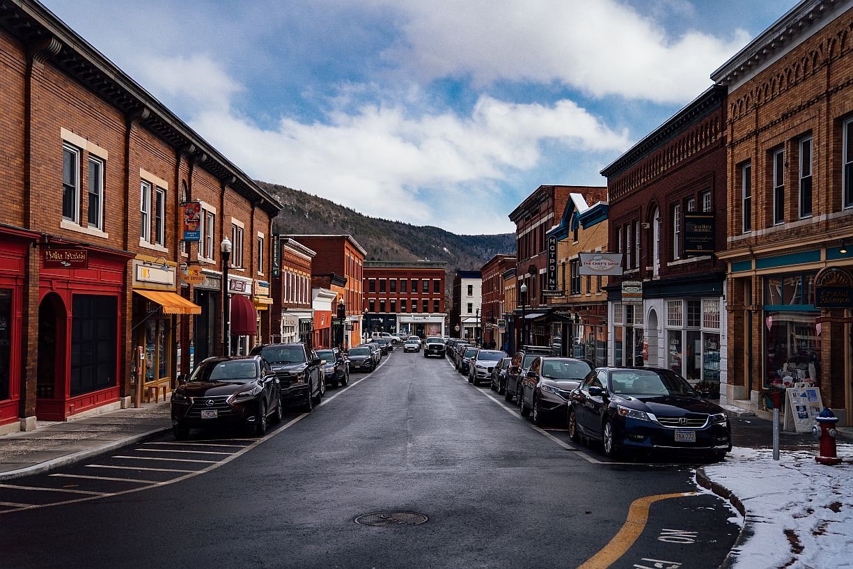 Classic New England main street with red brick buildings and Berkshire Hills in the background in winter