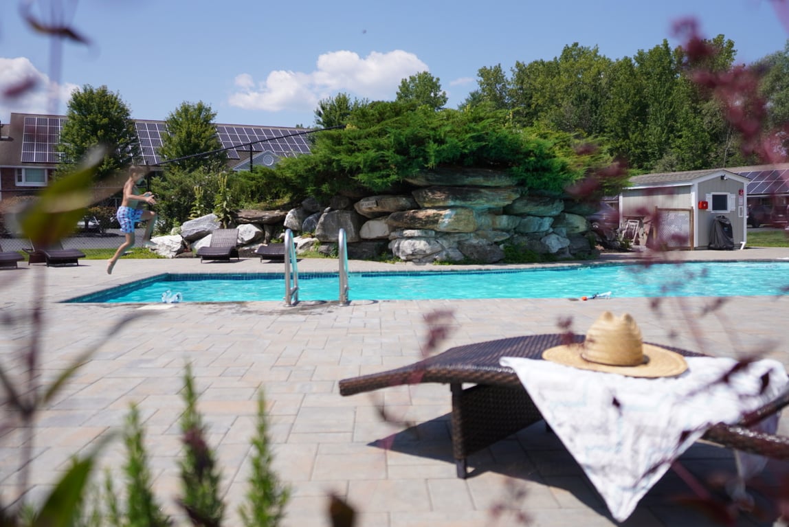 A kid jumping into the Yankee Inn's outdoor pool.