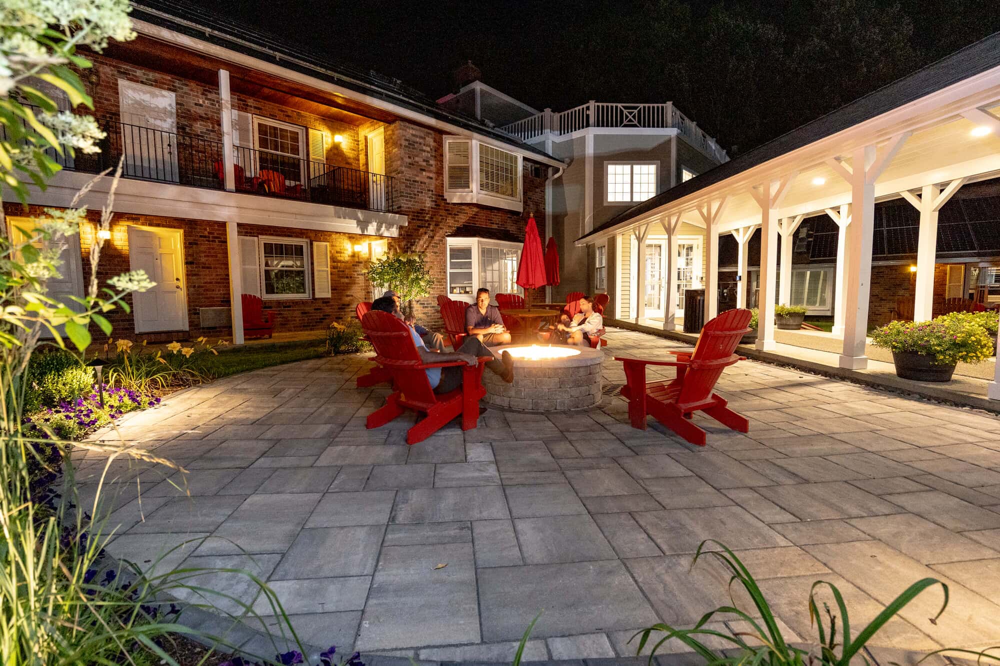 People gathered around the fire pit, in the Yankee Inn in Berkshires.