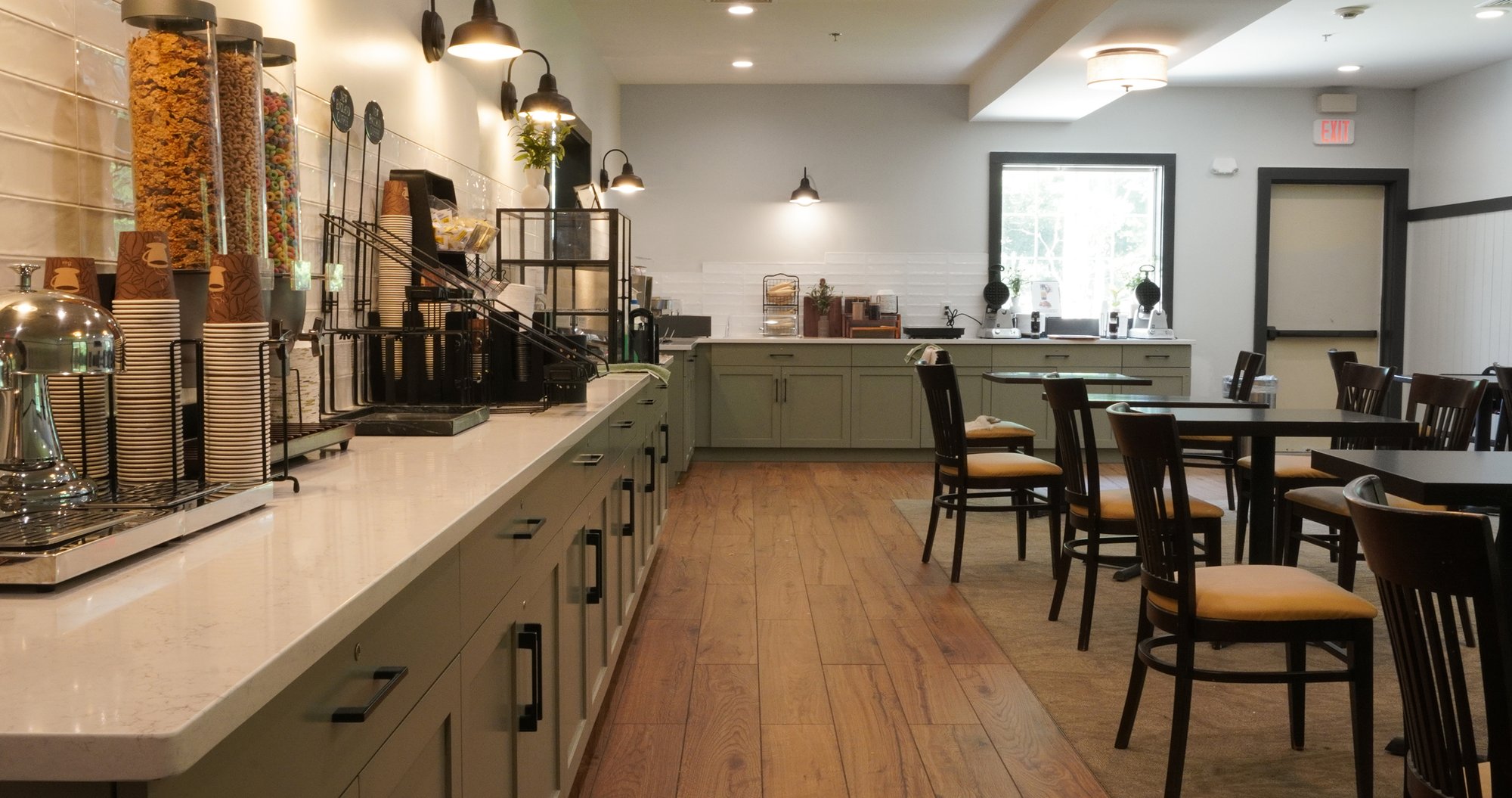 On-site breakfast room with coffee station, cereal dispensers, and dining seating