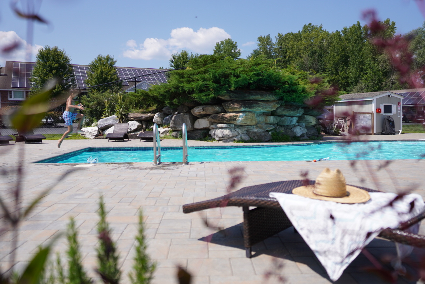 A kid jumping into the Yankee Inn's outdoor pool.
